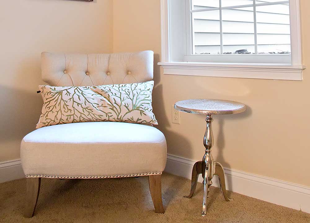 Chair and small table next to window